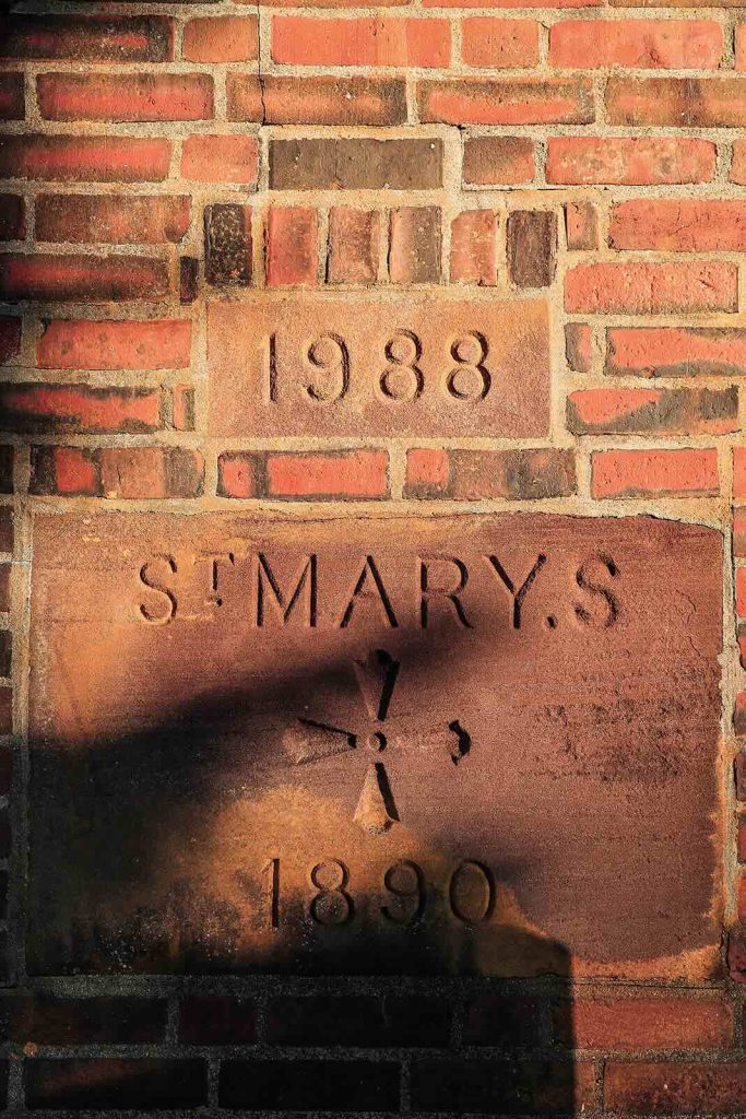 a stone plaque in a brick wall that says 1988 st marys 1890